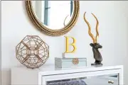  ??  ?? Brass accessorie­s, one of the hottest finishes in home decor, can be impactful when paired together. (Design Recipes)