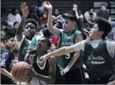  ?? Signal file photo ?? Several kids from the Boys & Girls Club of Santa Clarita Valley play in a basketball game last year. The organizati­on welcomed several new board members during a retreat Tuesday.