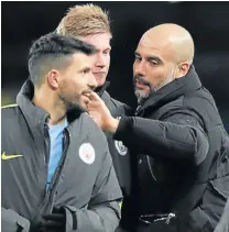  ?? Picture: GETTY IMAGES ?? TAP ON THE BACK: Manchester City manager Pep Guardiola celebrates with Sergio Aguero, left, and Kevin de Bruyne after the FA Cup quarterfin­al replay match at the Etihad Stadium, Manchester