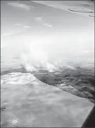  ?? AP ?? Plumes of smoke rise from a fire near Deniliquin, Australia, on Tuesday in this photo provided by the New South Wales Rural Fire Service.