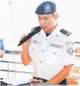  ??  ?? A SRB officer uses the public address system to inform passengers to proceed to the departure area.