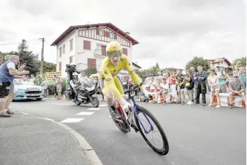  ?? — AFP photo ?? Great Britain’s Geraint Thomas, wearing the overall leader’s yellow jersey, rides during the 20th stage of the 105th edition of the Tour de France cycling race, a 31-kilometer individual time-trial between Saint-Pee-sur-Nivelle and Espelette.