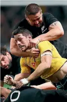  ?? HANNAH PETERS/GETTY IMAGES ?? All Blacks hooker Dane Coles tackles Wallabies pivot Bernard Foley in Dunedin on Saturday night.