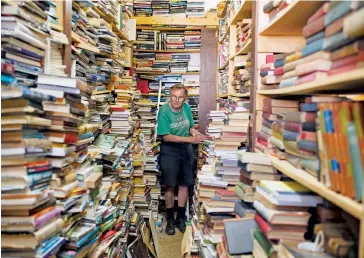  ??  ?? Crawford, 73, will happily climb a ladder to retrieve a book from the store’s more obscure sections