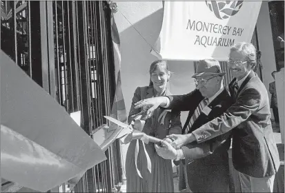  ?? MONTEREY HERALD ARCHIVES ?? Julie Packard, Pacific Grove Mayor Florus Williams and Monterey Mayor Clyde Roberson, cut the ribbon during the grand opening of the Monterey Bay Aquarium on Oct. 20, 1984.