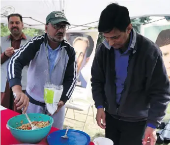  ?? MATT OLSON ?? Zubair Sheikh and Waqar Younus were serving up chana chaat at the Eid Street Festival in front of Saskatoon’s Copland Crescent mosque on Saturday. It marked the end of Eid al-adha, the Festival of Sacrifice.