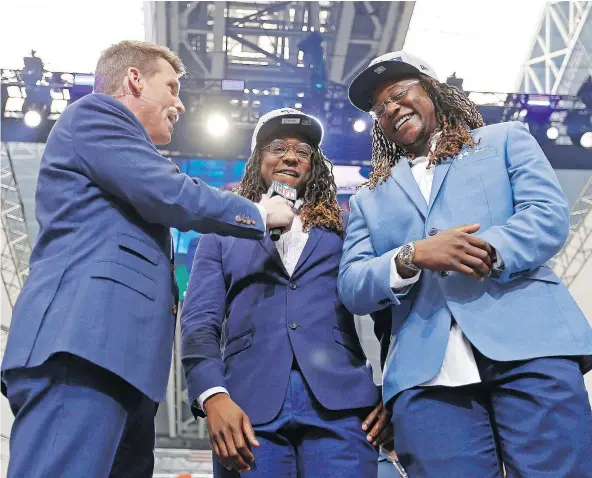  ?? — JAE S. LEE/THE DALLAS MORNING NEWS VIA AP ?? NFL Network’s Scott Hanson, left, talks with Seattle Seahawks cornerback Shaquill Griffin, centre, and his twin brother Shaquem Griffin after the Seahawks picked Shaquem in the fourth round of the NFL draft in Arlington, Texas, Saturday.