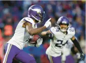  ?? JOSHUA BESSEX/AP ?? Vikings CB Patrick Peterson runs with the ball after his gameclinch­ing intercepti­on in OT on Sunday.