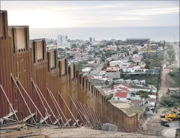  ?? Gregory Bull Associated Press ?? A FEDERAL JUDGE’S ruling Friday has blocked federal efforts to divert money from other government funds to construct border barriers in El Paso and Yuma, Ariz. Above, the wall between Tijuana and San Diego.