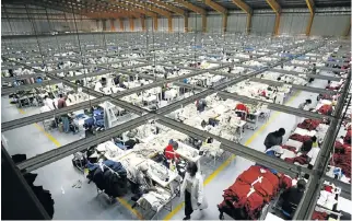  ?? /Reuters ?? Targeting of new markets: Workers at the Alltex clothing factory near Nairobi, Kenya. The African Continenta­l Free Trade Area agreement will help boost intraAfric­an trade.