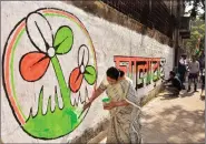  ?? ANI ?? Trinamool Congress MP Mala Roy paints a graffiti of the party symbol during an election campaign ahead of the Kolkata Municipal Corporatio­n Elections, in Kolkata on Saturday.