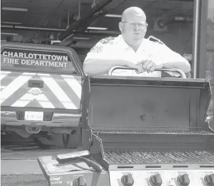  ?? JIM DAY/THE GUARDIAN ?? Charlottet­own fire inspector Winston Bryan hopes to encourage apartment building owners to better enforce a long-time ban against using propane and charcoal barbecues on their decks.