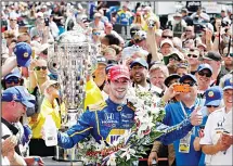  ??  ?? In this May 29, 2016 file photo, Alexander Rossi celebrates after winning the 100th running of the Indianapol­is 500 auto race at Indianapol­is Motor
Speedway in Indianapol­is. (AP)