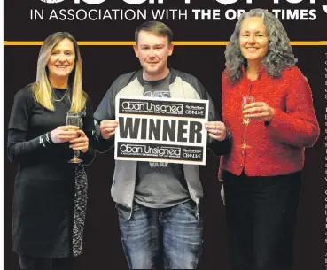  ??  ?? K9 Kev is congratula­ted by Oban Times editor Susan Windram, right, and Pauline Clifford.