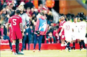  ?? PAUL ELLIS/AFP ?? Liverpool manager Jurgen Klopp (left) speaks with Georginio Wijnaldum after his side’s 2-2 Champions League draw with Sevilla at Anfield on September 13.