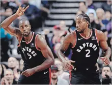  ?? NATHAN DENETTE THE CANADIAN PRESS ?? Raptors’ Serge Ibaka (9) celebrates a basket against the Charlotte Hornets with Kawhi Leonard in the first half in Toronto on Monday night.