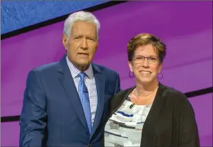  ?? Submitted photo ?? Lethbridge resident Sharon Lawson poses with “Jeopardy!” host Alex Trebek on the set of the popular TV quiz show.