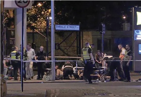  ?? PHOTO: FEDERICA DE CARIA/PA ?? INJURIES: Police and emergency services treat attack victims in Thrale Street near London Bridge.