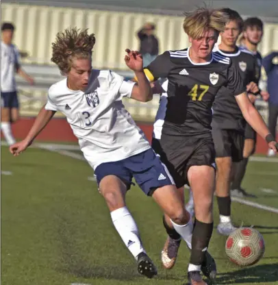  ?? Dan Watson/ The Signal ?? West Ranch sophomore Logan Bates (13) and Golden Valley junior Alex Risdon (47) fight for the ball during Tuesday’s Foothill League matchup at Golden Valley High School. Golden Valley won, 2-0, to seal a postseason spot for the second straight year.