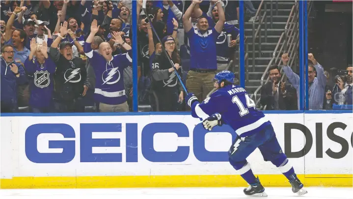  ?? KIM KLEMENT/USA TODAY SPORTS ?? Tampa Bay's Pat Maroon celebrates his third-period goal with fans at Amalie Arena on Monday as the Lightning scored a 2-0 series-clinching win.