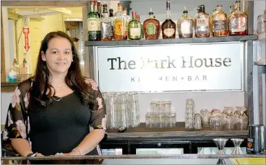  ?? Marc Hayot/Herald Leader ?? Part of Park House’s appeal is having a full bar and vibrant nightlife. Alma Sanchez poses behind the bar at Park House Kitchen + Bar.