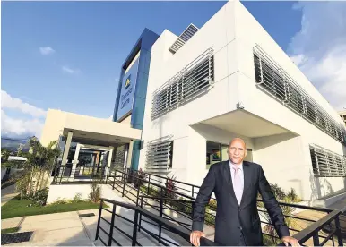  ?? CONTRIBUTE­D PHOTOS ?? Managing Director of JN Fund Managers Alan Lewis in front of the upgraded JN Financial Centre in New Kingston.