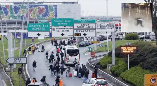  ??  ?? PARIS: Travelers walk on the highway to the Orly airport, south of Paris yesterday. (inset) A picture taken of a television screen shows a man lying on the ground of a terminal building at Paris’ Orly airport after he was shot by French security forces...