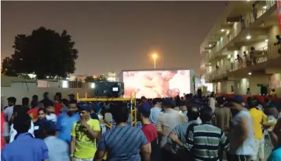  ??  ?? Workers are delighted to find a mobile cinema unit coming at their doorsteps. The initiative will benefit 15,000 workers in Dubai.