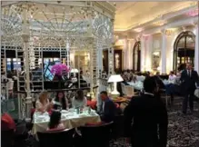  ?? NANCY NATHAN, FOR THE WASHINGTON POST ?? Afternoon tea at the Thames Foyer at the Savoy Hotel, alongside a glass cupola that dates to 1904.