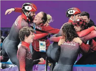  ?? PAUL CHIASSON THE CANADIAN PRESS ?? Charles Hamelin, centre back, celebrates with Marianne St-Gelais after winning the bronze medal in the men’s 5,000-metre relay for Canada on Thursday.