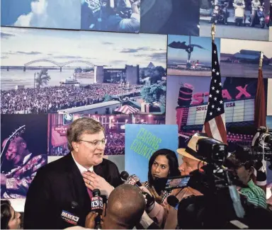  ??  ?? Memphis Mayor Jim Strickland answers questions from the media about the list requiring 81 people to receive a police escort in City Hall at the Greater Memphis Chamber.