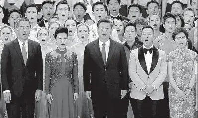  ?? AP/KIN CHEUNG ?? Chinese President Xi Jinping (center) joins new Hong Kong leader Carrie Lam (second from left), artists and officials in song during an event marking 20 years since the city became a semiautono­mous region after its hand-over from Great Britain to China.