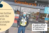  ??  ?? A police officer at Sainsbury’s in Melbourne