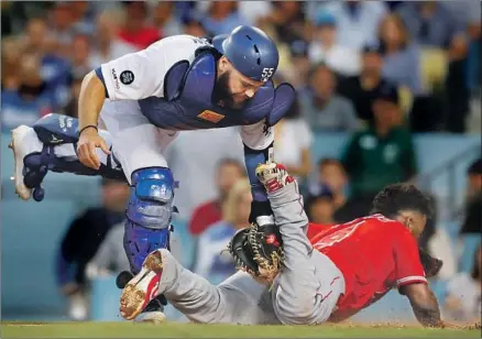  ?? Photograph­s by Luis Sinco Los Angeles Times ?? DODGERS CATCHER Russell Martin is late with the tag as Luis Rengifo scores the first run of the game on a second-inning single by Shohei Ohtani at Dodger Stadium. Kenta Maeda, who started for the Dodgers, couldn’t get out of the fifth inning.