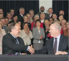  ?? THE CANADIAN PRESS/FILES ?? B.C. Green party Leader Andrew Weaver and NDP counterpar­t John Horgan shake hands after signing a deal on creating a stable minority government at the legislatur­e in May.