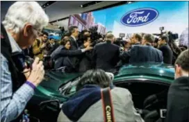  ?? JAKE MAY — THE FLINT JOURNAL-MLIVE.COM VIA AP ?? Members of the media interview Jim Hackett, President and CEO of Ford Motor Company in front of Ford’s new 2019 Mustang Bullitt at the North American Internatio­nal Auto Show, Sunday in Detroit.