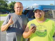  ?? Special to the Eagle Observer/DANIEL BEREZNICKI ?? Bobby Ballou (left) and Gritts (right) are the winners of the 68th Decatur Barbecue Festival cornhole tournament. Here they show their winnings of $145.