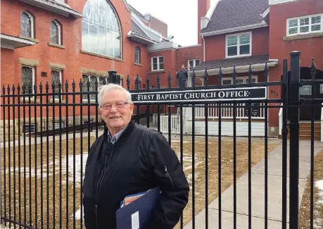  ?? PHOTOS: LICIA CORBELLA ?? David McMechan, chair of First Baptist Church’s maintenanc­e and finance committee, stands in front of the new wrought-iron fencing put up around the old manse. The fencing has been installed to prevent “some anti-social behaviour and refuse” on church grounds.