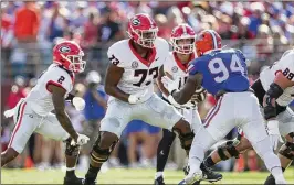  ?? JASON GETZ/JASON.GETZ@AJC.COM ?? Georgia lineman Xavier Truss (73) could have turned pro after last season but returned. The SEC may not dominate the draft’s first round this year.