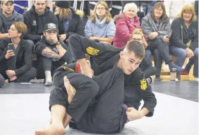  ?? FRAM DINSHAW/TRURO NEWS ?? Taylor Mccafferty, top, wrestled his fellow Marmac Athletics team member Zack Little to the floor in a gold medal bout. Off the mat, the pair are colleagues and friends, as well as skilled practition­ers of Brazilian jiu-jitsu. They both competed in Truro at the Jan. 18 Rogue Grappling 7 – Out Cold competitio­n.