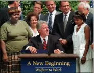  ?? J. SCOTT APPLEWHITE—ASSOCIATED PRESS ?? In this Aug. 22, 1996, file photo President Bill Clinton prepares to sign legislatio­n in the Rose Garden of the White House overhaulin­g America’s welfare system. Visible, from left, are former welfare recipients Lillie Harden, of Little Rock, Ark., and Janet Ferrel, of W.VA., Vice President Gore, West Virginia Gov. Gaston Caperton, Sen. John Breaux, D-LA., and former welfare recipient Penelope Howard, of Delaware.