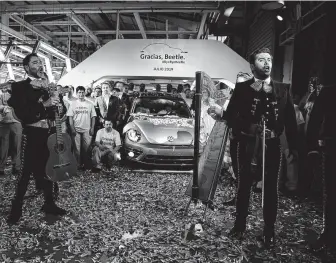  ?? Fernando Llano / Associated Press ?? A mariachi band sings the classic Mexican tune “Cielito Lindo” after the last Final Edition Beetle was rolled out under a confetti shower at the plant in Puebla, Mexico.