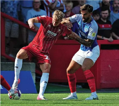  ?? Pictures: Nizaam Jones/ JMP ?? Portsmouth’s ex-cheltenham Town midfielder Marlon Pack battles with the Robins’ Taylor Perry