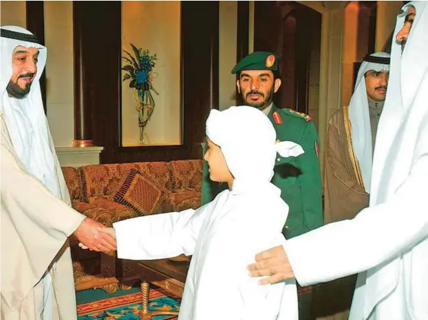  ?? Abdul Rahman/Gulf News Archives ?? Popular leader
Shaikh Khalifa receives Eid
Al Adha greetings from a boy and his father at the Guest Palace in Abu Dhabi in December 2006.