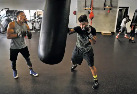  ?? Carlos Avila Gonzalez / The Chronicle ?? Karim Mayfield (left) works out with Keshon Wilson. Mayfield is set to fight Gaku Takahashi of Los Angeles on Saturday.