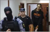  ?? EVGENIA NOVOZHENIN­A — POOL PHOTO VIA AP ?? American basketball star Brittney Griner, right, is escorted Wednesday to a courtroom in Khimki, Russia.