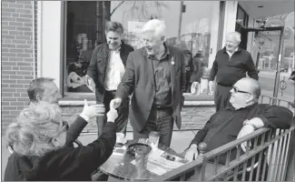  ?? MIKE CASSESE REUTERS FILE PHOTO ?? Liberal leader Bob Rae (centre) meeting voters in Toronto on Monday: his fiscal record as premier of Ontario 20 years ago compares quite favourably with Prime Minister Stephen Harper’s own.