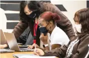  ??  ?? LEFT: Students work in class at Ombudsman Chicago South alternativ­e school in Chicago Lawn.