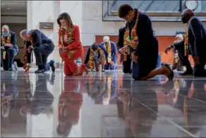  ?? MANUEL BALCE CENETA / AP ?? House Speaker Nancy Pelosi (center) and other members of Congress kneel and observe a moment of silence at the Capitol’s Emancipati­on Hall on Monday in Washington, reading the names of George Floyd and others killed during police interactio­ns.