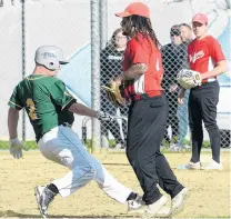  ?? PHOTO: LINDA ROBERTSON ?? Making it safely . . . Cardinals runner Mark Christian makes it to second base as Dodgers players Hoani IvaKeen (left) and Logan Herbert (background) watch on during the premier men’s club softball final at Ellis Park on Saturday.